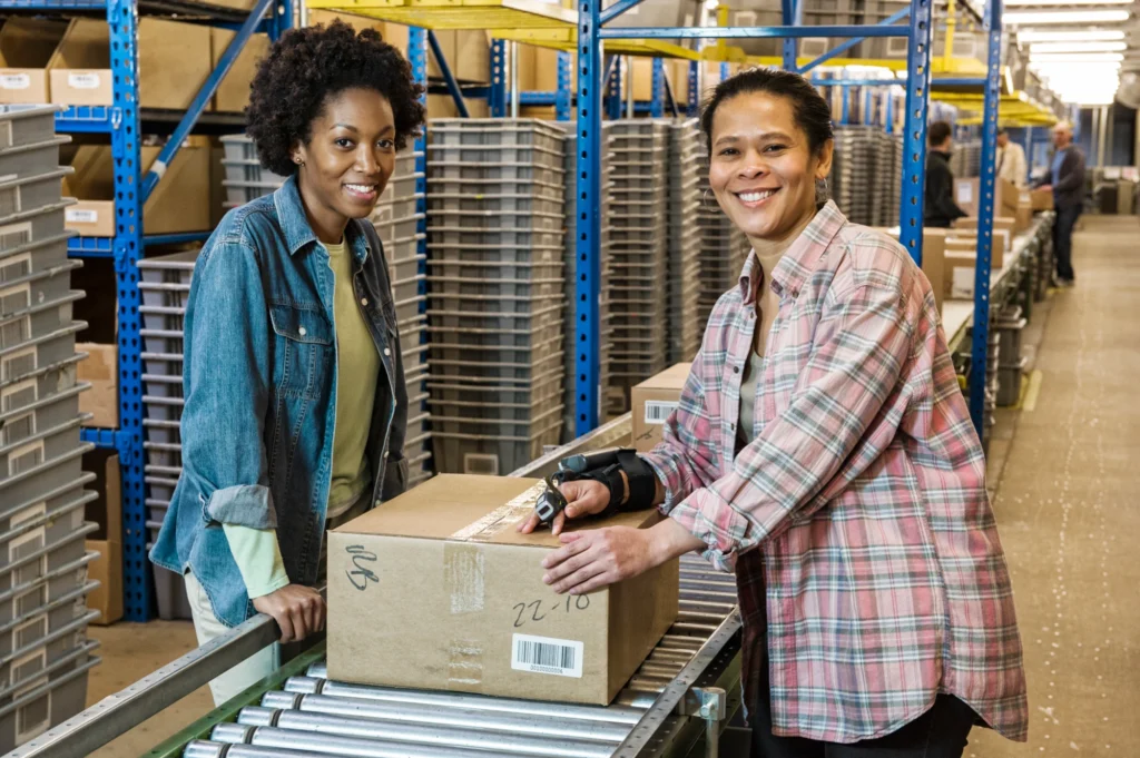 Employees working on a conveyor belt. Warehouse distribution